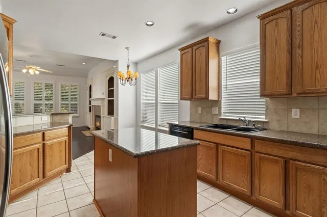 a kitchen with stainless steel appliances granite countertop a sink and a stove