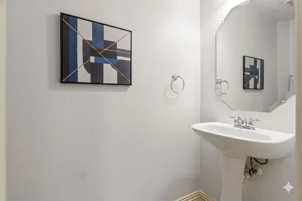 a bathroom with a sink and mirror