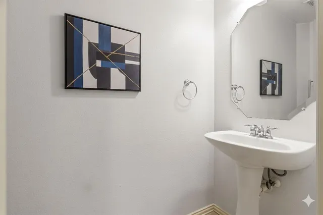 a bathroom with a sink and mirror