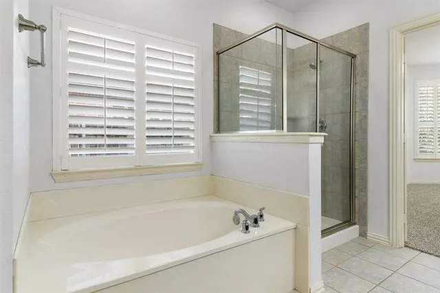 a bathroom with a bathtub and a shower