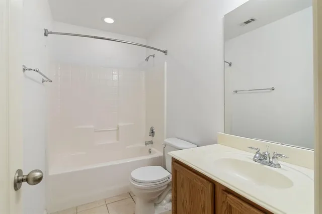 a bathroom with a sink toilet vanity and shower