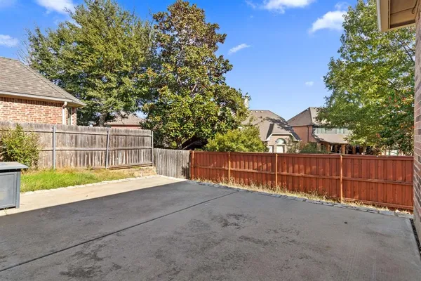 a view of a backyard with a tree