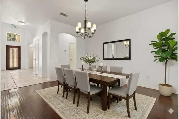 a view of a dining room with furniture and chandelier