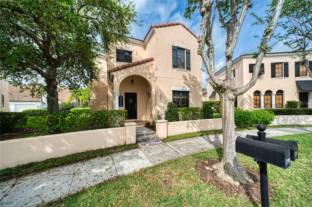 a front view of a house with garden and patio