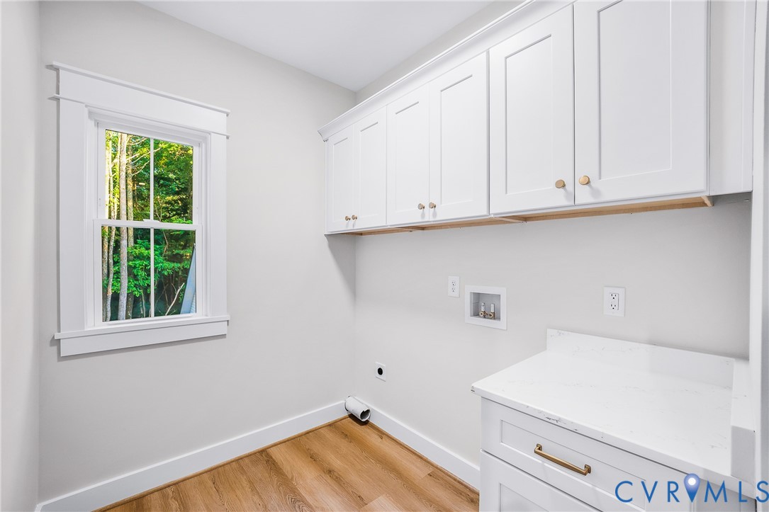 8299 Pamlico Road Ashland, VA 23005 - Photo 23 of 35 a view of a kitchen with white cabinets and a wooden floor