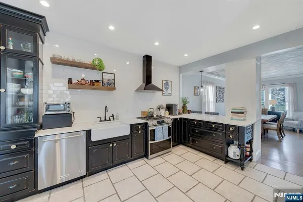 a kitchen with stainless steel appliances kitchen island granite countertop a sink and cabinets