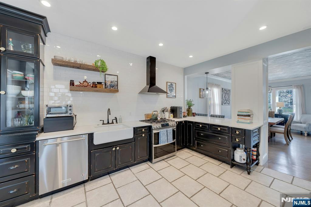158 Carmita Avenue Rutherford, NJ 07070 - Photo 11 of 43 a kitchen with stainless steel appliances kitchen island granite countertop a sink and cabinets