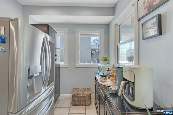 a view of kitchen with furniture and windows