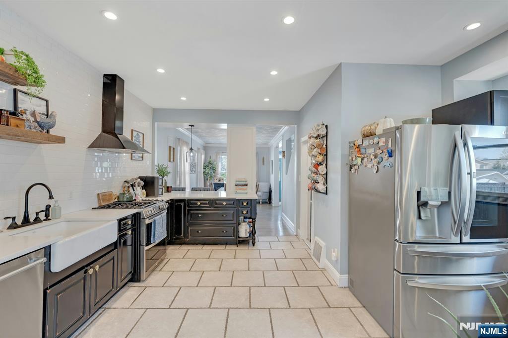 158 Carmita Avenue Rutherford, NJ 07070 - Photo 13 of 43 a kitchen with stainless steel appliances a refrigerator sink and stove