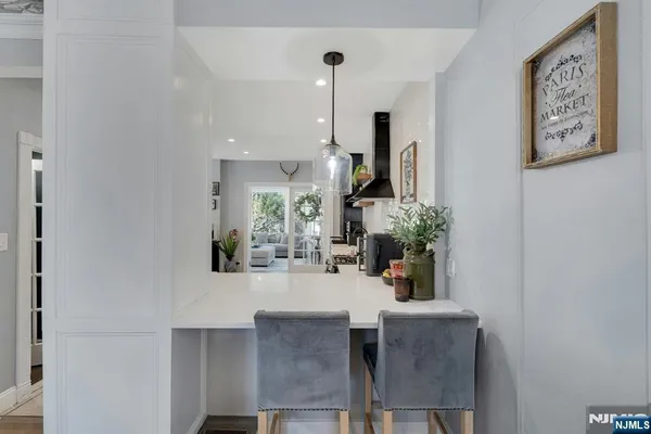 a view of a dining room with furniture and a potted plant