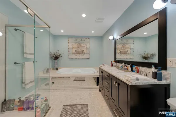 a bathroom with a double vanity sink mirror double and shower