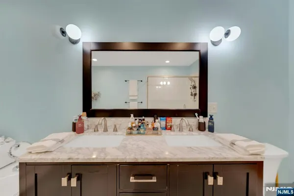 a bathroom with a granite countertop sink and a mirror