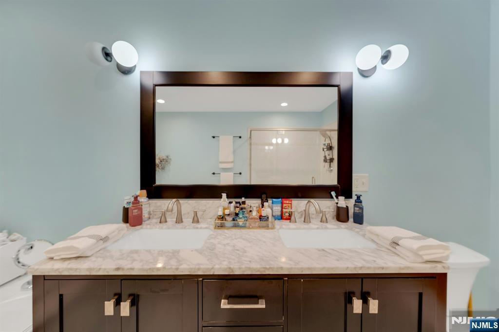 158 Carmita Avenue Rutherford, NJ 07070 - Photo 24 of 43 a bathroom with a granite countertop sink and a mirror