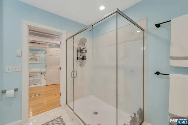 a bathroom with a glass shower door