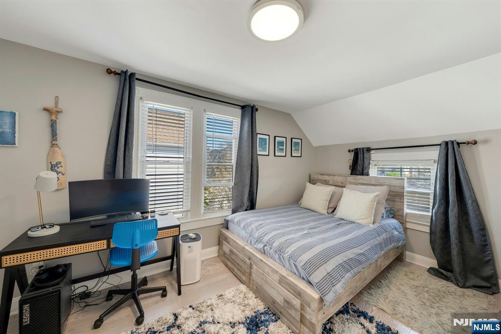 158 Carmita Avenue Rutherford, NJ 07070 - Photo 27 of 43 a bedroom with a bed and a computer on a desk next to a window
