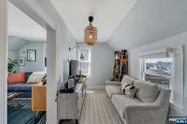 a living room with furniture stairs and a window