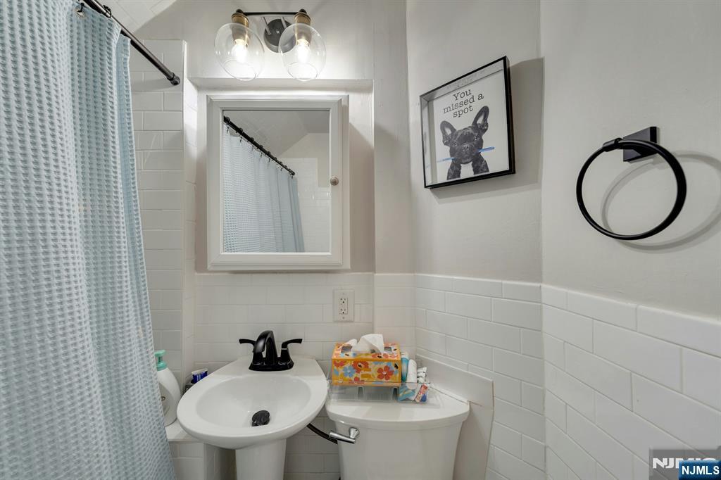 158 Carmita Avenue Rutherford, NJ 07070 - Photo 31 of 43 a bathroom with a sink mirror and toilet