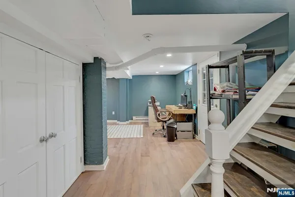 a living room with furniture and a piano