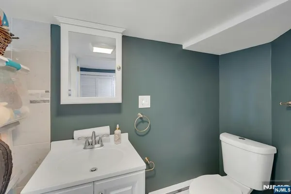 a bathroom with a sink toilet and a mirror