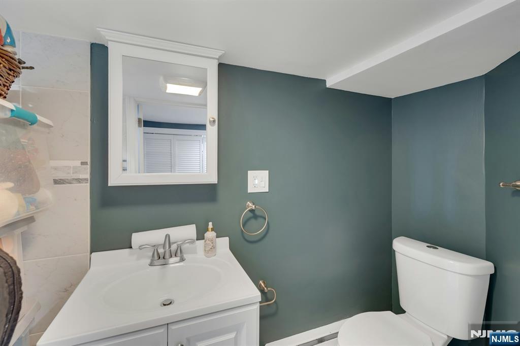 158 Carmita Avenue Rutherford, NJ 07070 - Photo 35 of 43 a bathroom with a sink toilet and a mirror