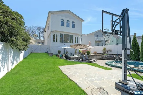 a view of a house with backyard and sitting area
