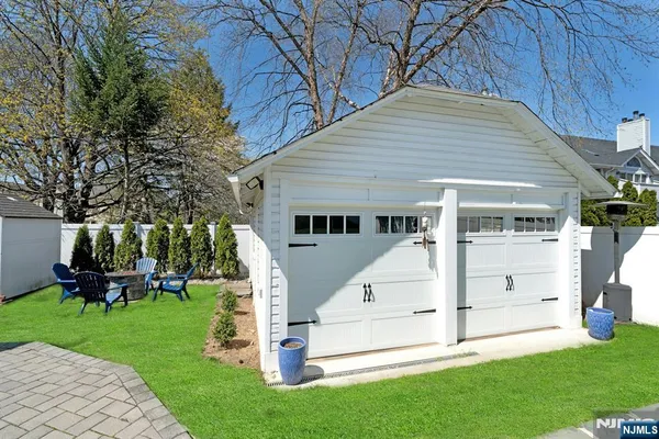 a view of house with garden and chairs