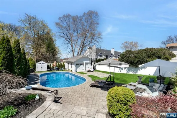 a swimming pool with outdoor seating and yard
