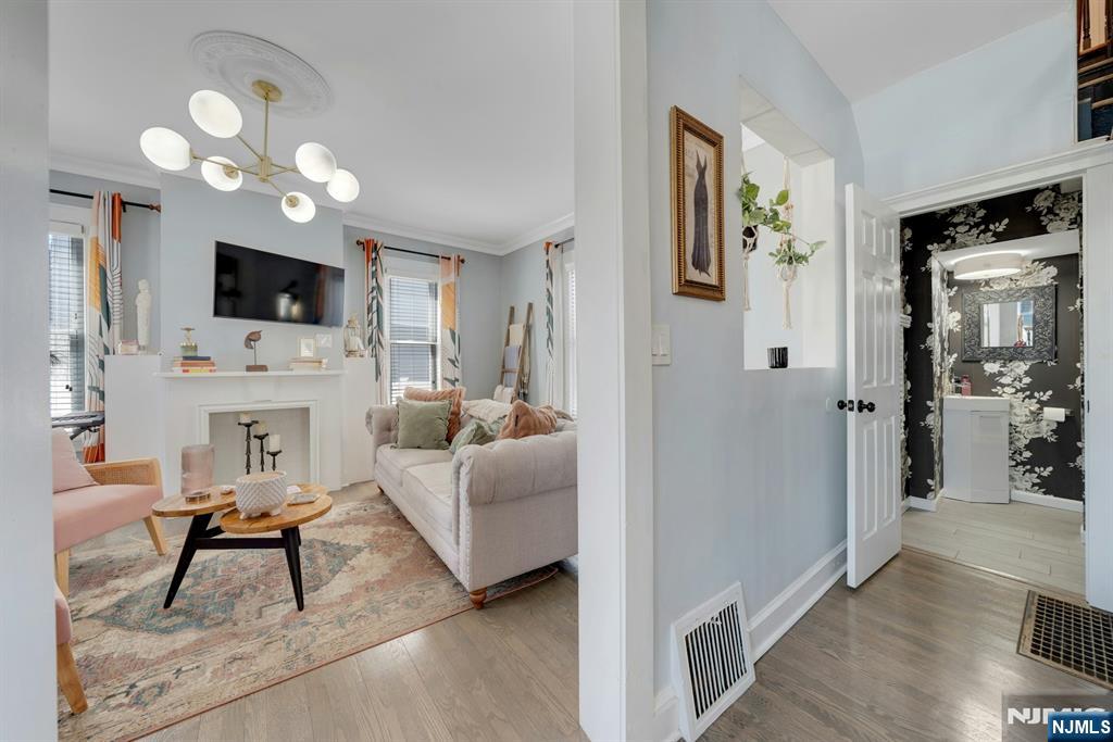158 Carmita Avenue Rutherford, NJ 07070 - Photo 5 of 43 a living room with furniture a fireplace and a flat screen tv