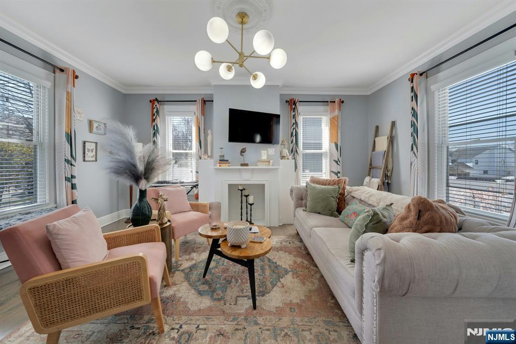 158 Carmita Avenue Rutherford, NJ 07070 - Photo 6 of 43 a living room with furniture a flat screen tv and a fireplace