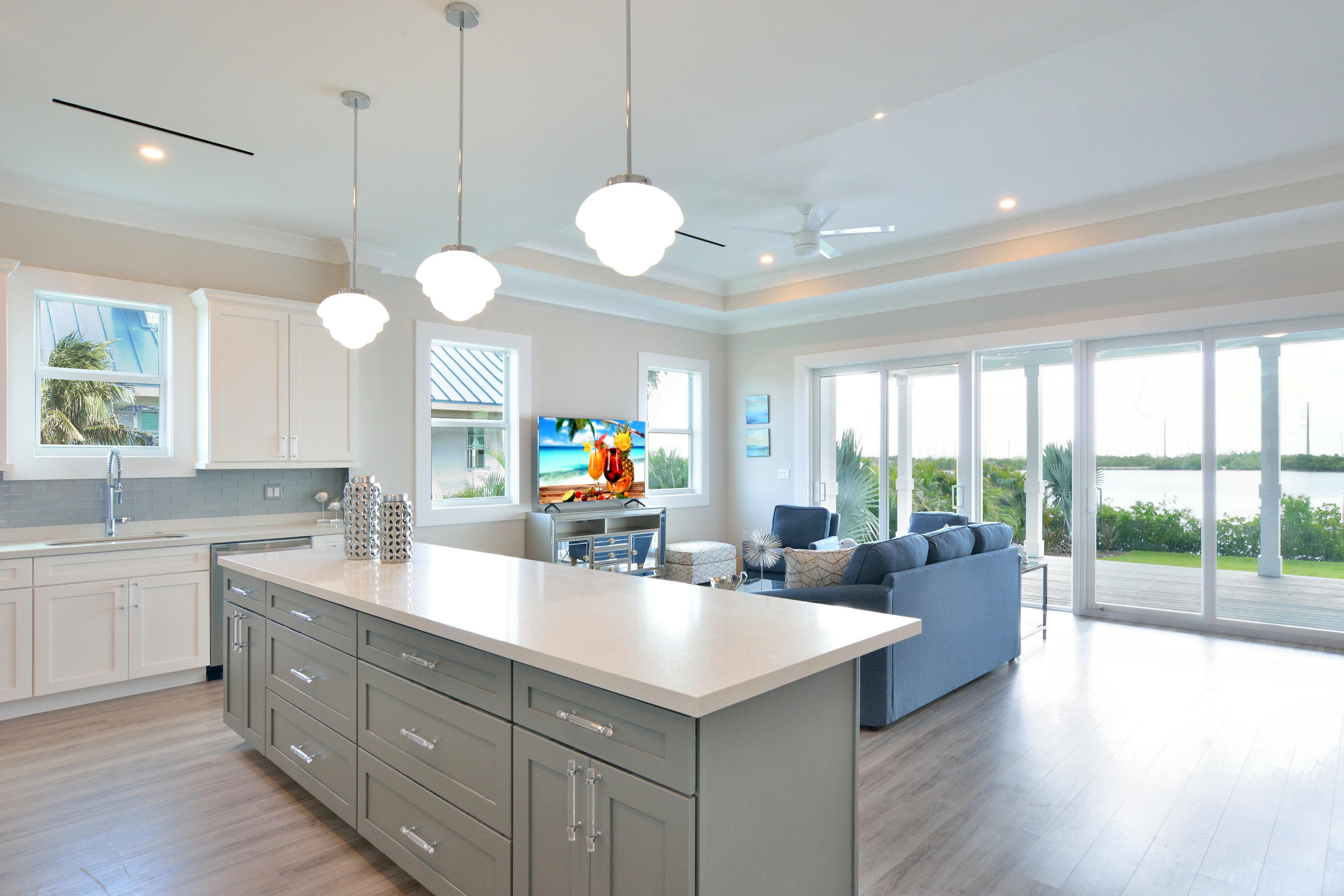 37 Key Haven Road Key West, FL 33040 - Photo 3 of 9 a kitchen with kitchen island granite countertop a sink cabinets and a large window
