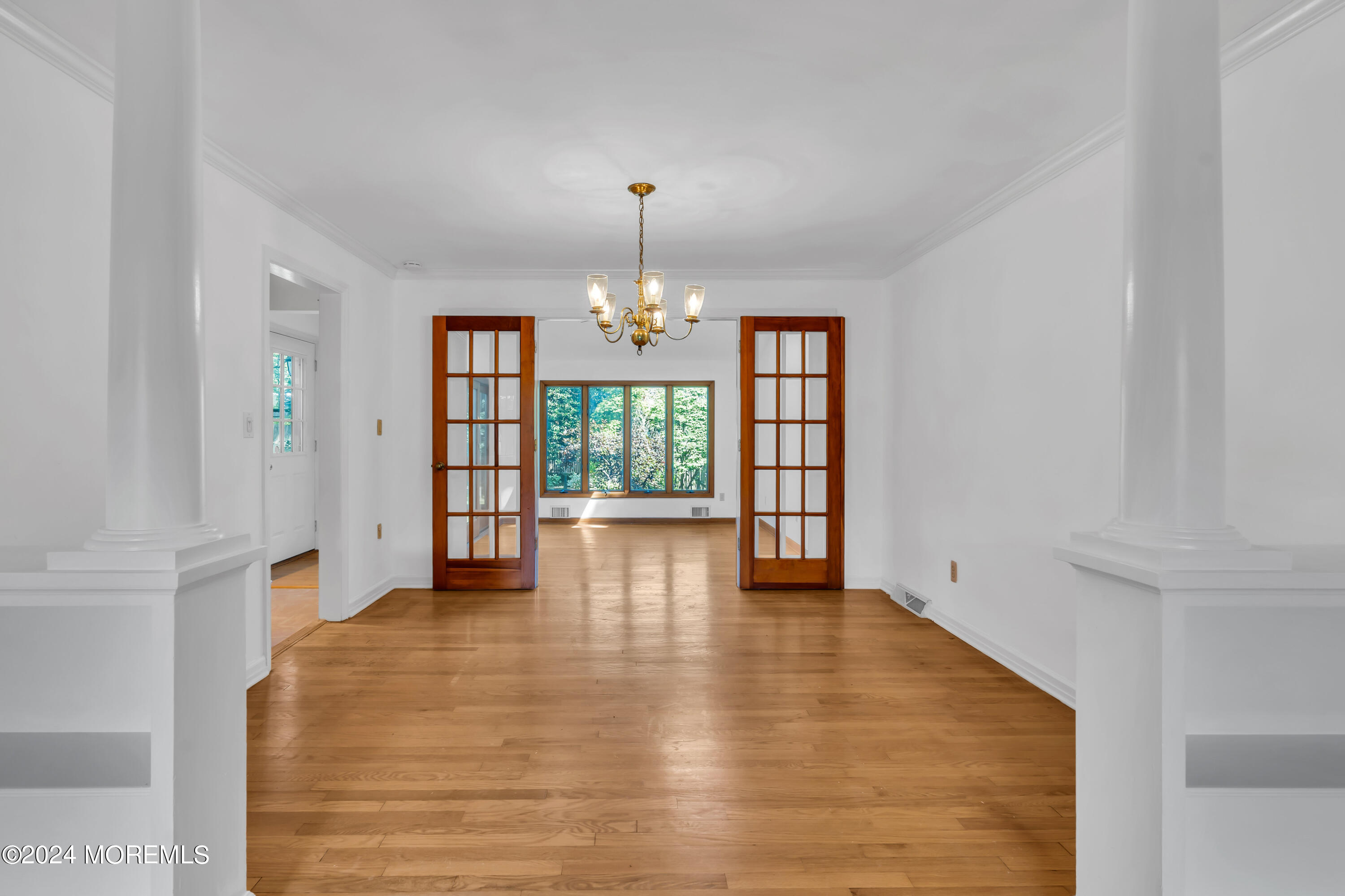 85 Hance Road Fair Haven, NJ 07704 - Photo 11 of 42 a view of an empty room with window and wooden floor