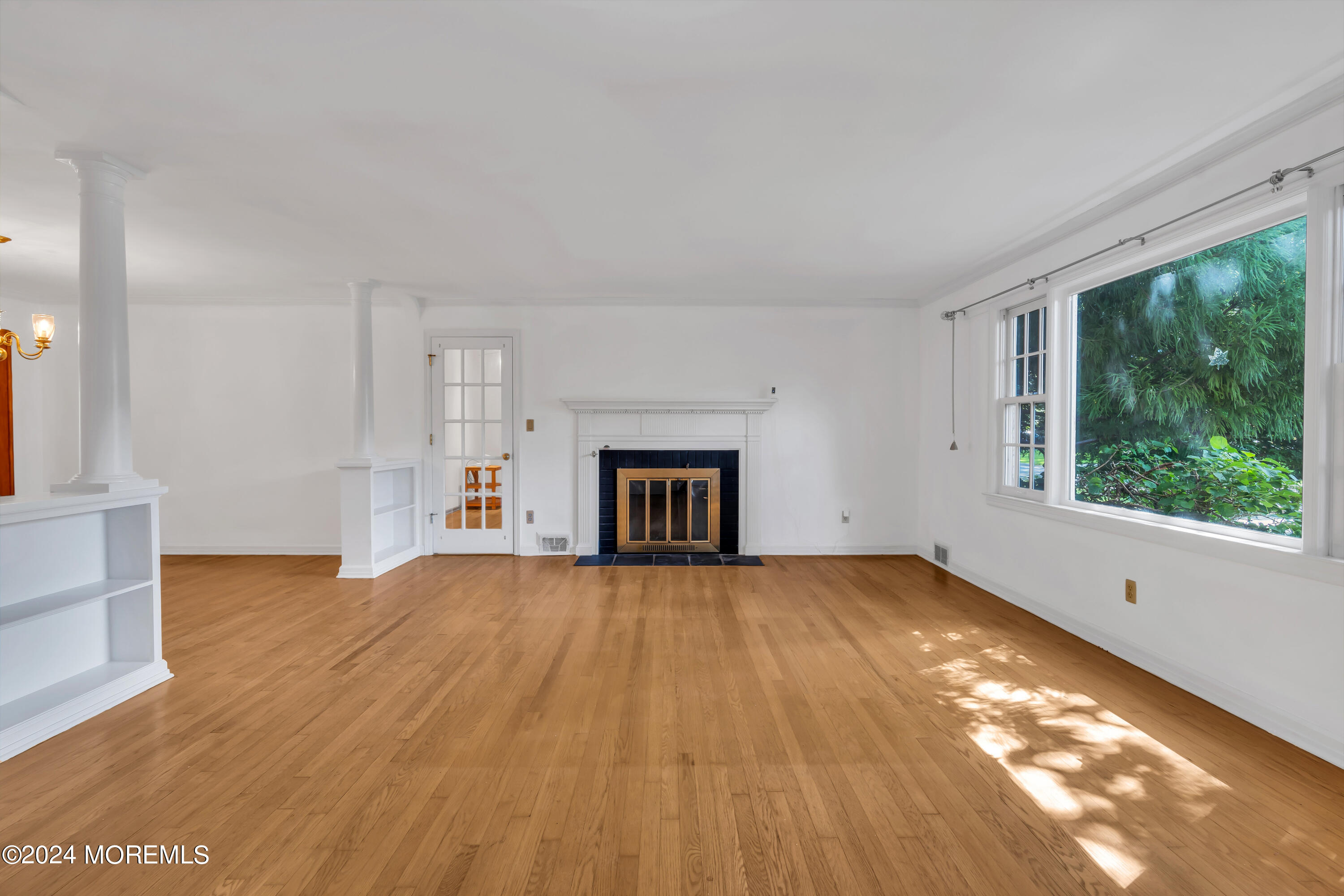 85 Hance Road Fair Haven, NJ 07704 - Photo 5 of 42 a view of an empty room with wooden floor and a window