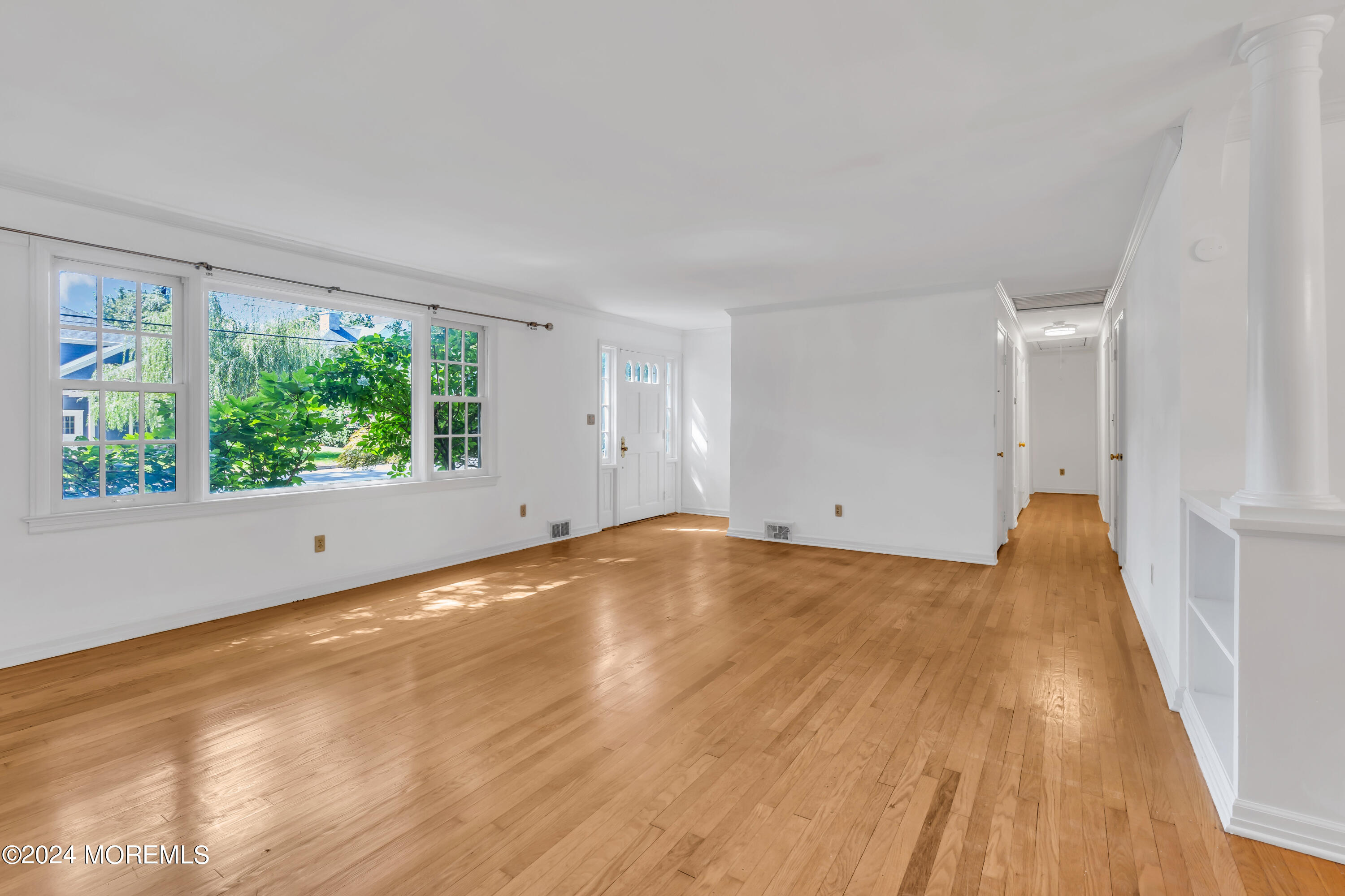 85 Hance Road Fair Haven, NJ 07704 - Photo 7 of 42 a view of empty room with wooden floor and fan