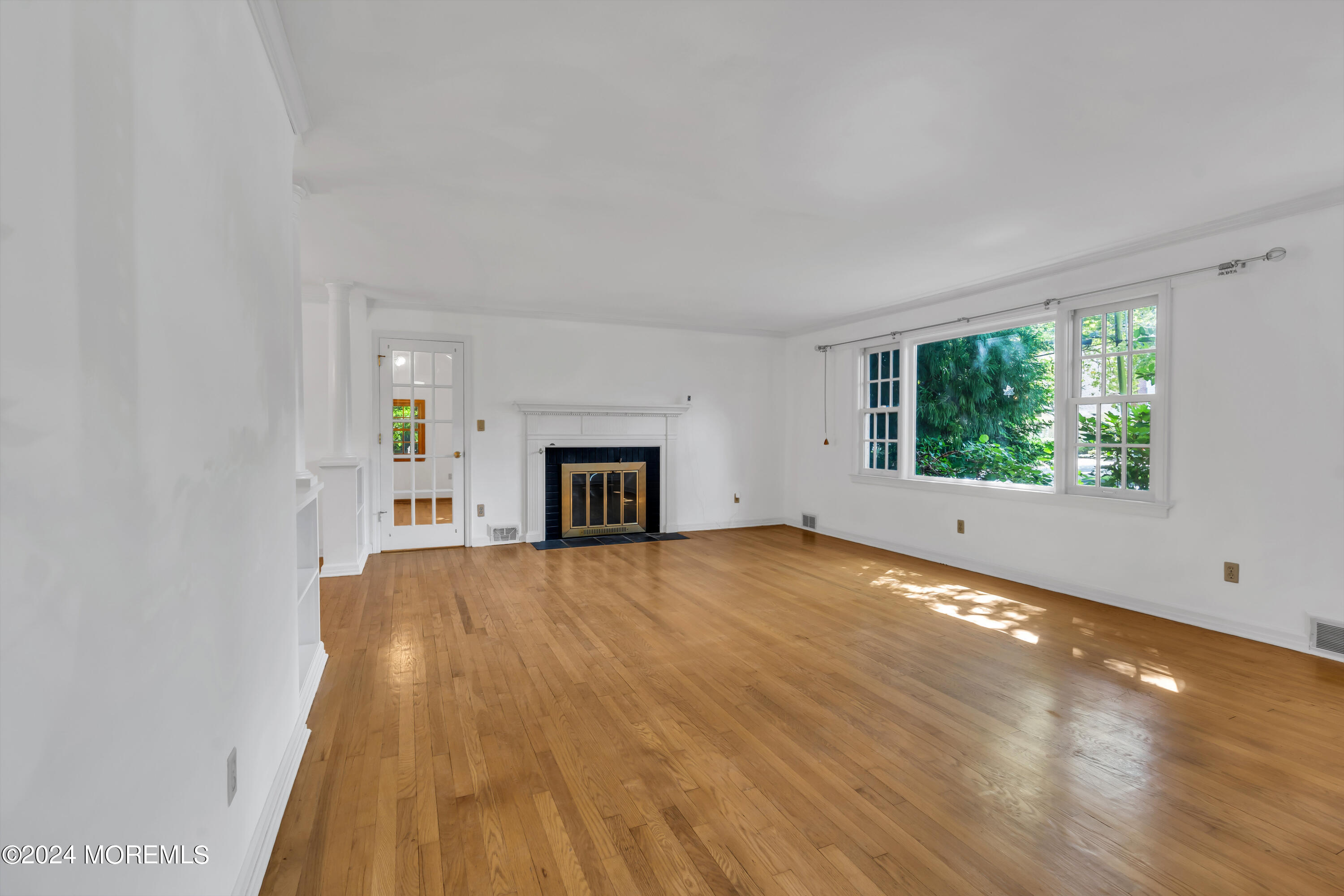 85 Hance Road Fair Haven, NJ 07704 - Photo 8 of 42 a view of empty room with wooden floor and fireplace