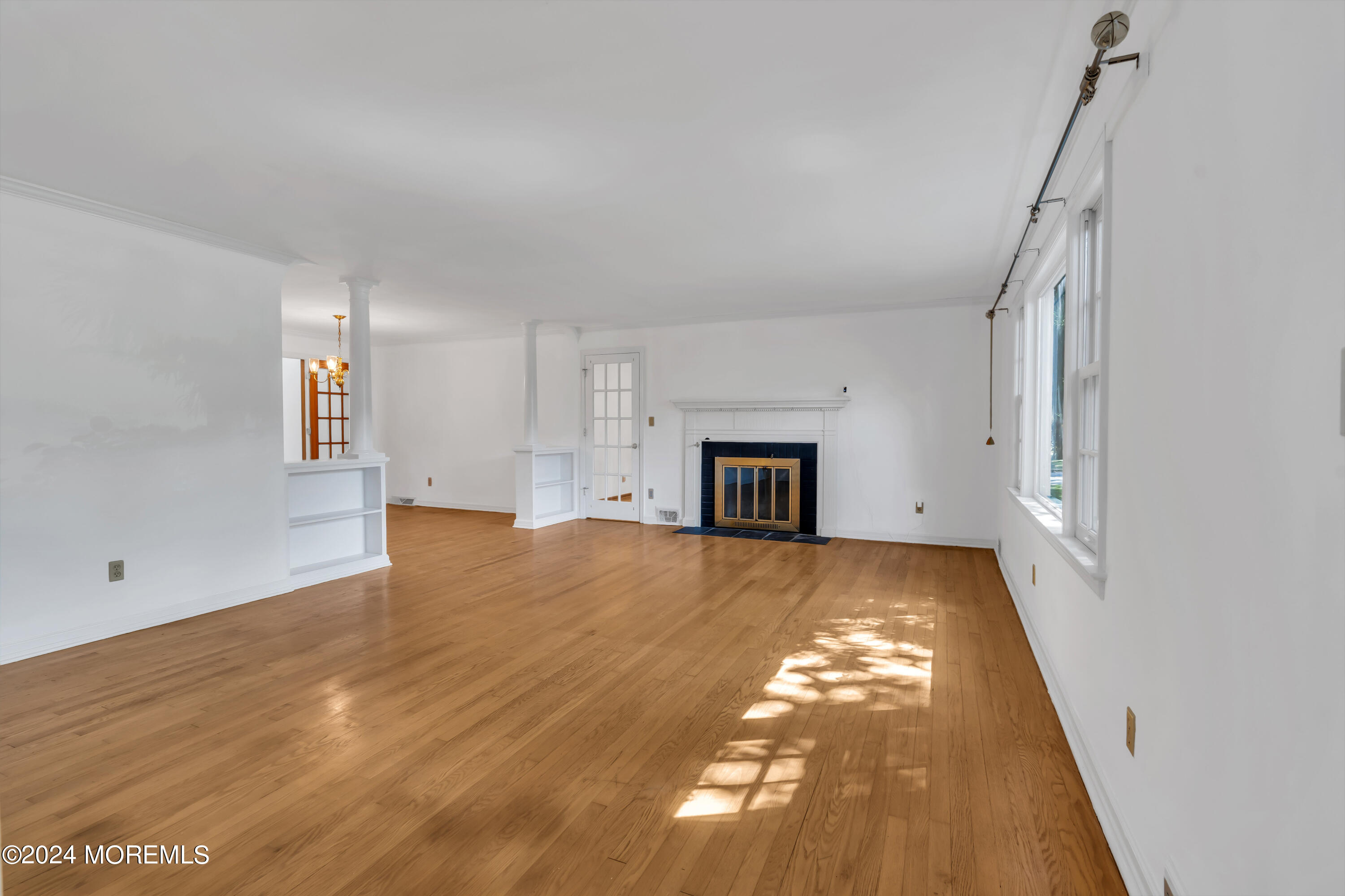 85 Hance Road Fair Haven, NJ 07704 - Photo 9 of 42 a view of empty room with wooden floor and fireplace