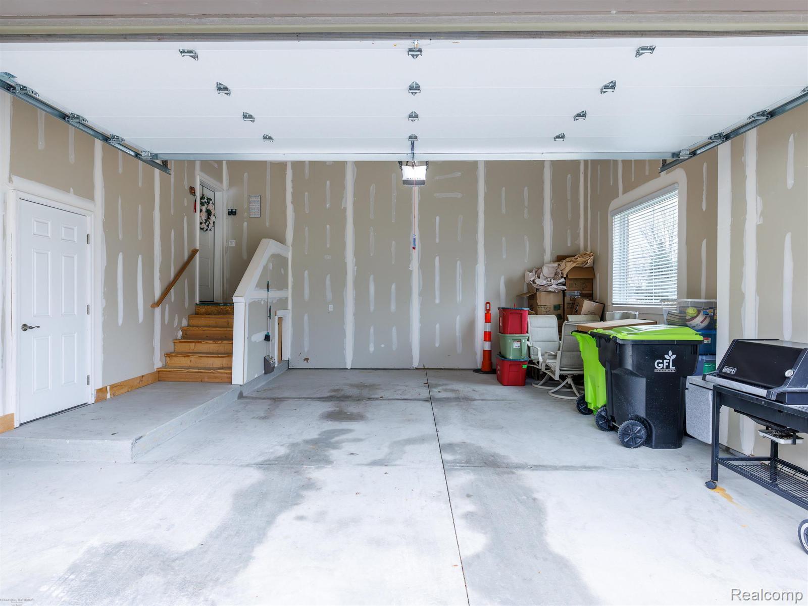 47705 Card Road Macomb, MI 48044 - Photo 44 of 53 Spacious garage with concrete flooring, unfinished drywall, and a window for natural light