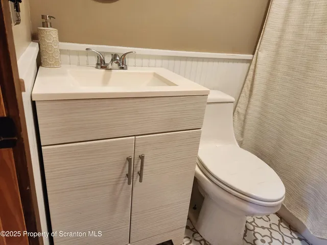 a kitchen with appliances cabinets and a wooden floor