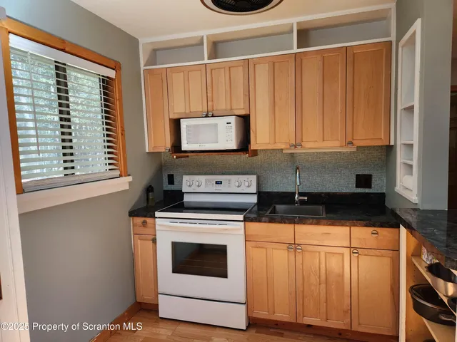 a white refrigerator freezer sitting inside of a kitchen
