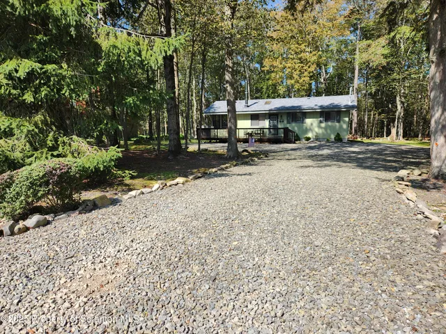 a front view of a building with a garden