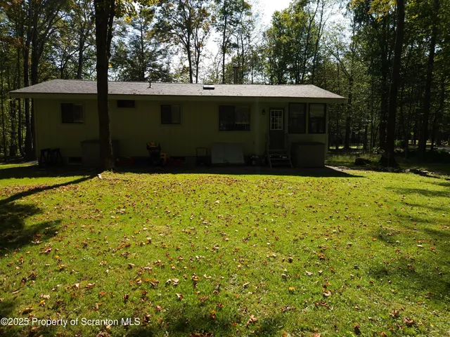 a swimming pool with outdoor seating and yard