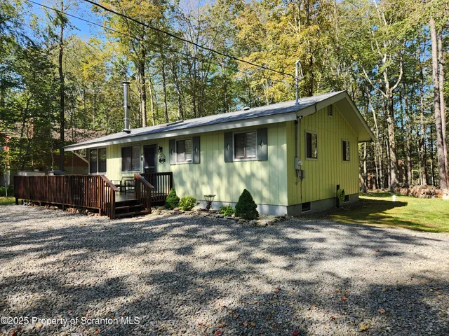 a view of a house with backyard and trees