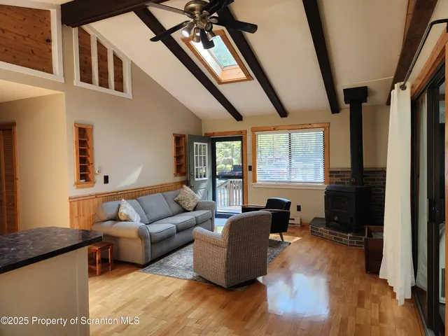 a view of a livingroom with wooden floor and a window