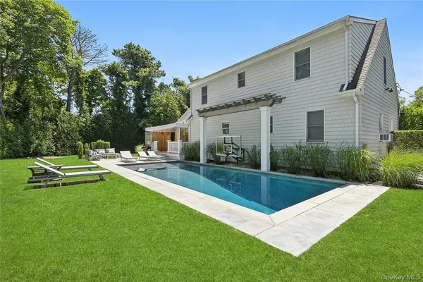 a view of a house with a yard patio and swimming pool