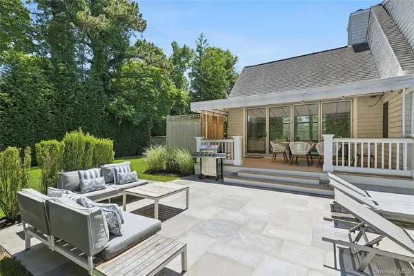 a view of a patio with table and chairs and potted plants