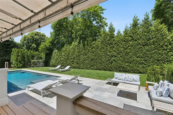 a view of a backyard with sitting area