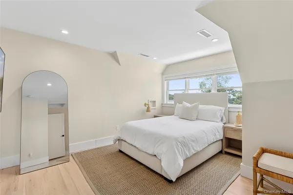 a bedroom with a bed and a large window