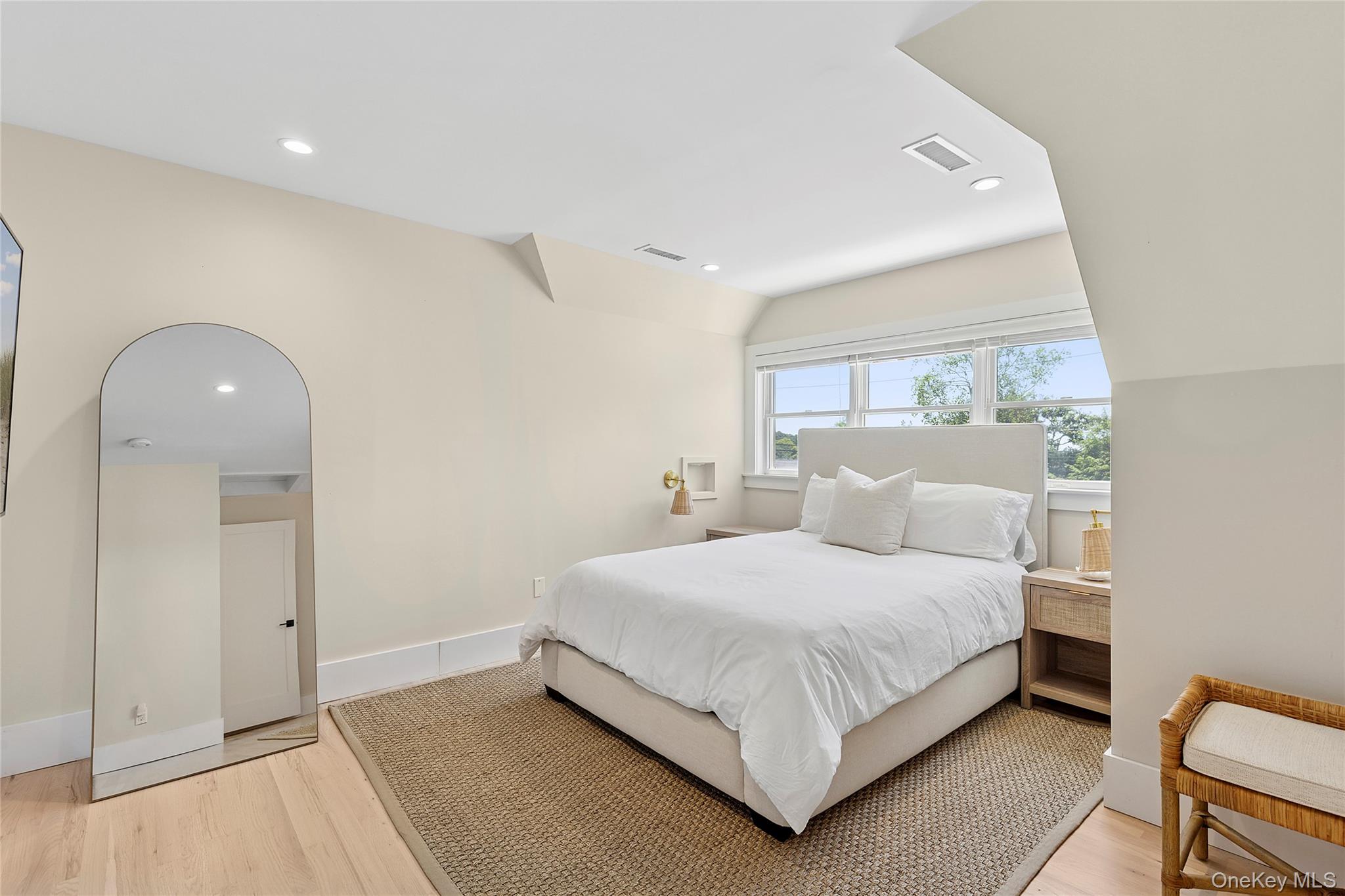 31 Highland Road Southampton, NY 11968 - Photo 9 of 19 a bedroom with a bed and a large window