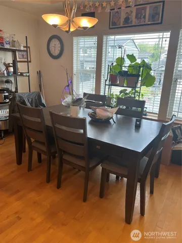 a view of a dining room with a table and chairs