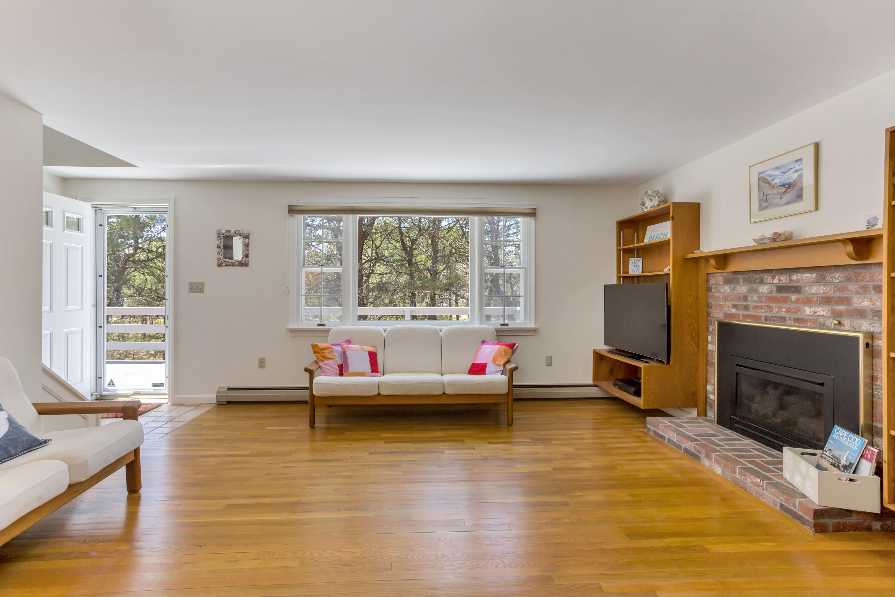 140 Salt Works Road Eastham, MA 02642 - Photo 12 of 49 a living room with fireplace furniture and a large window