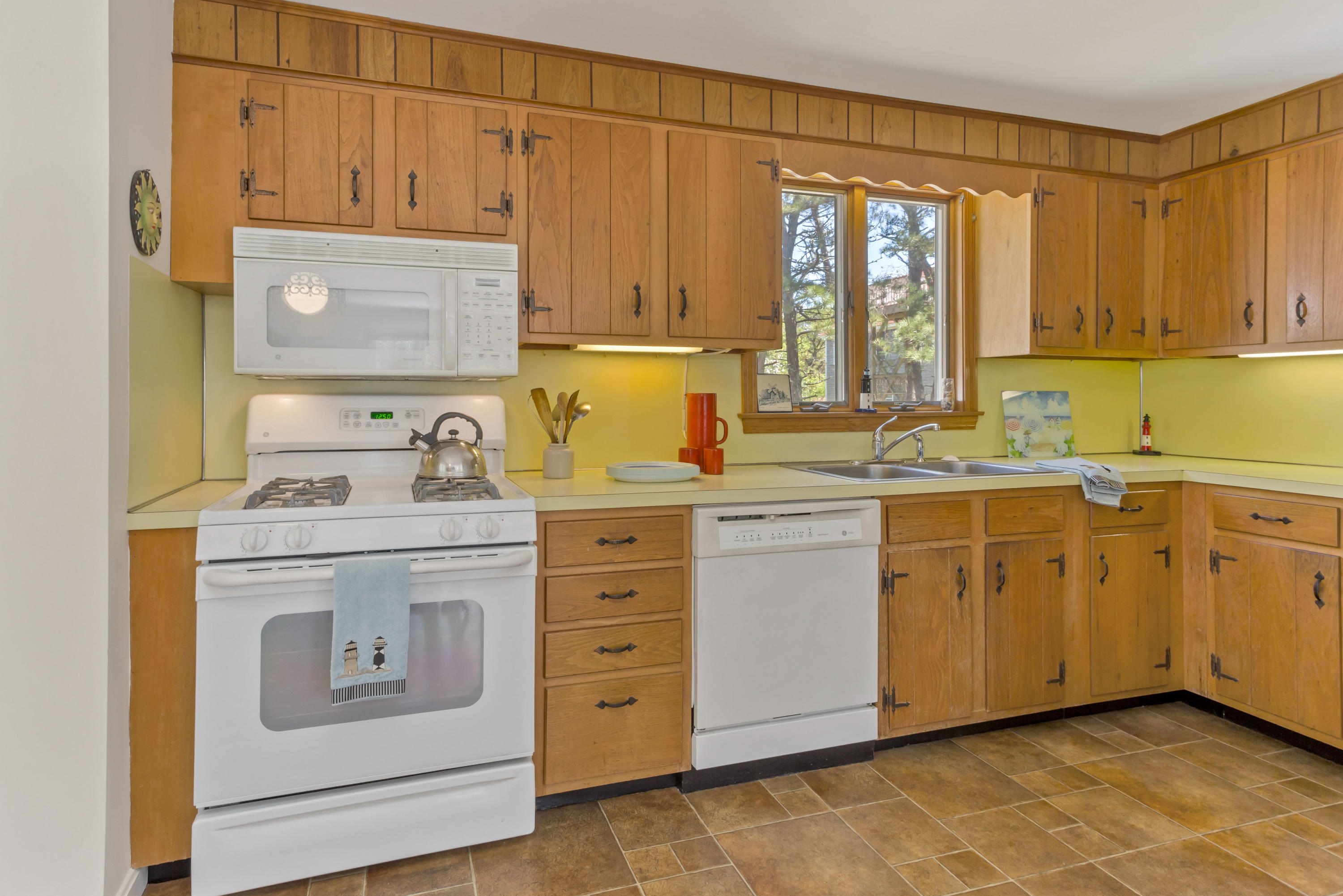 140 Salt Works Road Eastham, MA 02642 - Photo 15 of 49 a kitchen with cabinets appliances a sink and a window
